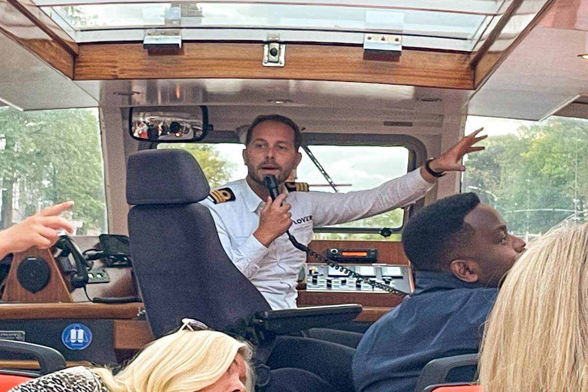 The captain showing guests some of the Amsterdam landmarks on the Lovers Dinner cruise